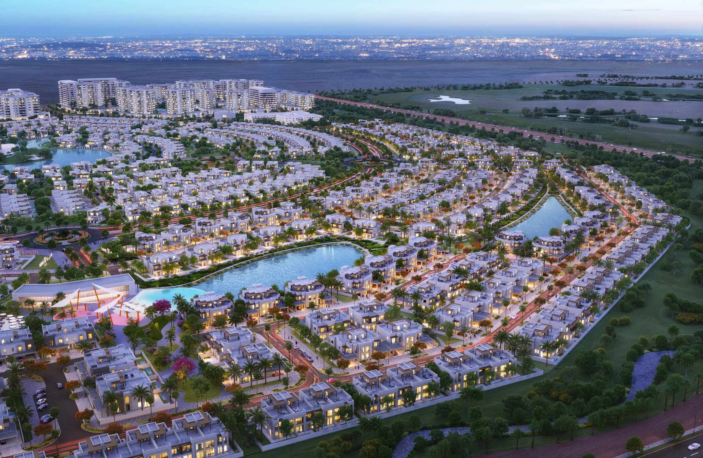 Rakennus ulkoa hämärässä — Hayat by Dubai South