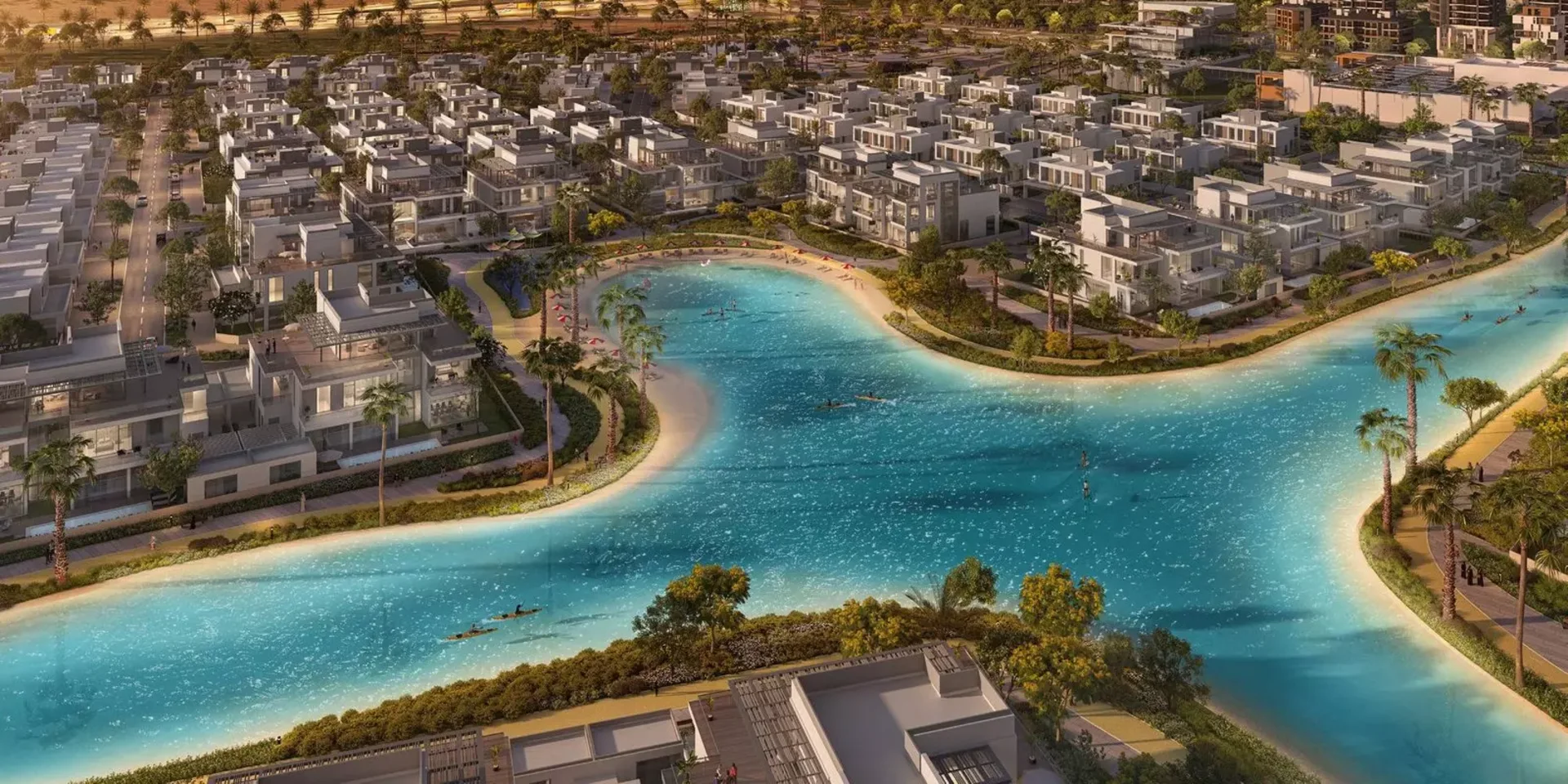 Vue aérienne de The Pulse à Dubai South, rangées de townhouses autour du lagon baignable